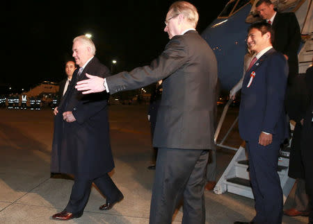 U.S. Secretary of State Rex Tillerson, left, is escorted to his car upon his arrival during his first trip to Asia as Secretary, at Haneda International Airport in Tokyo, Wednesday, March 15, 2017. REUTERS/Eugene Hoshiko/Pool