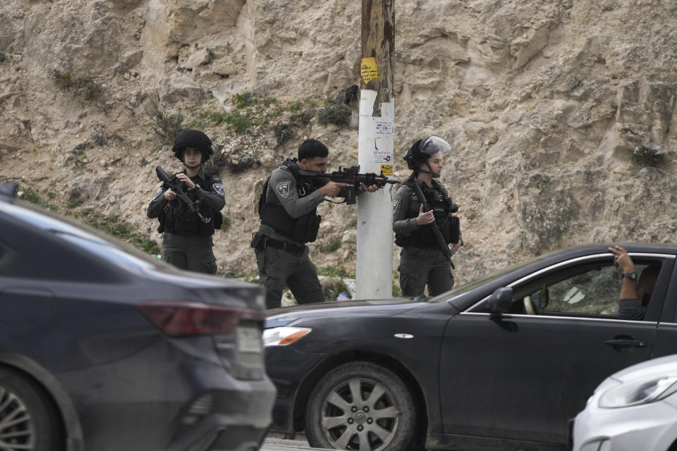 Israeli security forces secure the site where policemen examine the body of a Palestinian attacker outside the Israeli settlement of Maale Adumim, in the West Bank, Monday, Feb. 5, 2024. (AP Photo/Mahmoud Illean)