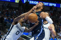 Dallas Mavericks guard Jalen Brunson, center, reacts after being hit by Memphis Grizzlies guard De'Anthony Melton (0) during the second half of an NBA basketball game, Saturday, Dec. 4, 2021, in Dallas. (AP Photo/Sam Hodde)