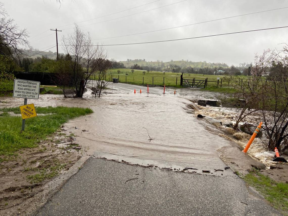 Big Creek floods across a bridge and culvert at Highway 168 and Vineyard Lane in the Fresno County foothills outside Clovis on March 10, 2023. 