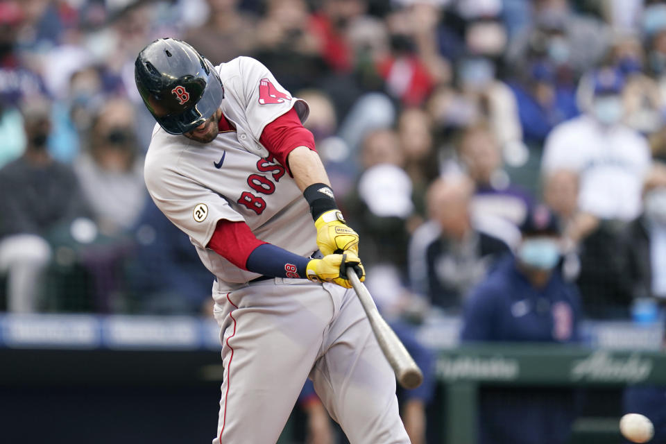 Boston Red Sox's J.D. Martinez singles in a run against the Seattle Mariners in the 10th inning of a baseball game Wednesday, Sept. 15, 2021, in Seattle. (AP Photo/Elaine Thompson)