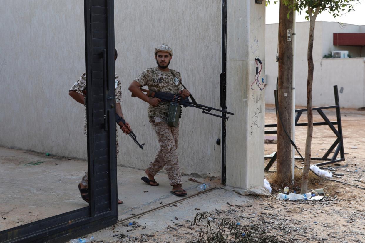 Members of Libya's internationally recognised government forces carry weapons in Ain Zara, Tripoli, in October: Reuters