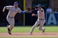 Jul 15, 2018; San Diego, CA, USA; Chicago Cubs third baseman David Bote (13) snags a grounder in front of shortstop Addison Russell (27) before throwing out San Diego Padres left fielder Wil Myers (not pictured) in the seventh inning at Petco Park. Mandatory Credit: Jake Roth-USA TODAY Sports
