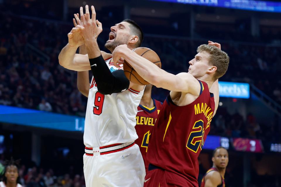 Cavaliers forweard Lauri Markkanen (24) steals the ball from Chicago Bulls' Nikola Vucevic (9) during the first half of the Bulls' 98-94 win Saturday night in Cleveland. [Ron Schwane/Associated Press]