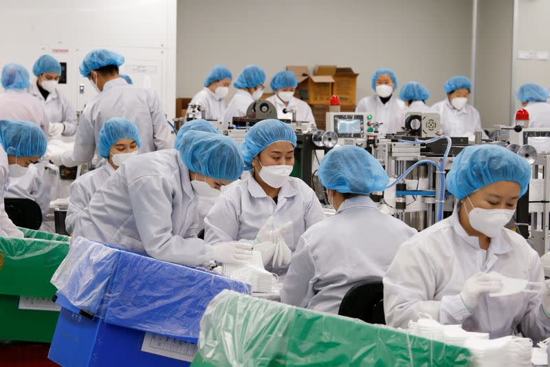 Employees work at a mask factory in Icheon