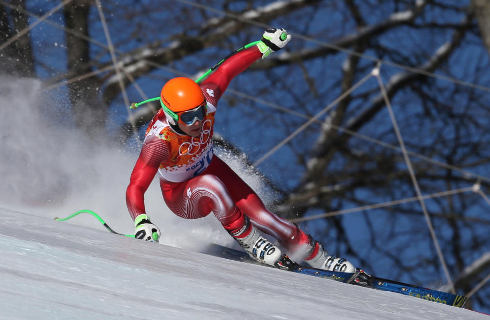 Switzerland's Patrick Kueng makes a turn during men's downhill training at the Sochi 2014 Winter Olympics, Thursday, Feb. 6, 2014, in Krasnaya Polyana, Russia. (AP Photo/Luca Bruno)