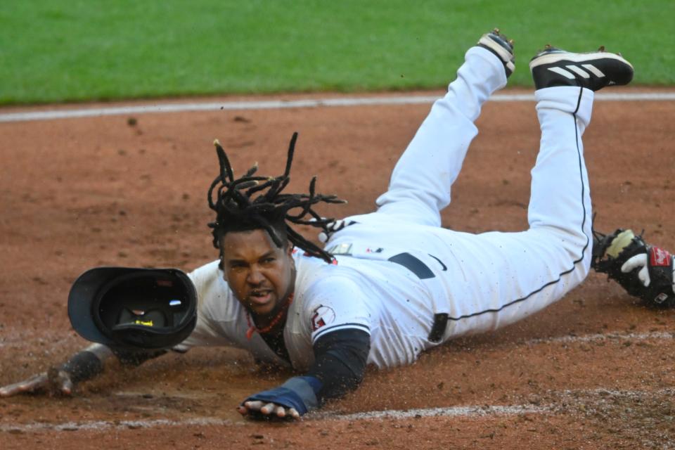 Cleveland Guardians third baseman Jose Ramirez (11) slides to home plate before being tagged out by Minnesota Twins catcher Christian Vazquez (8) in the third inning Saturday at Progressive Field.