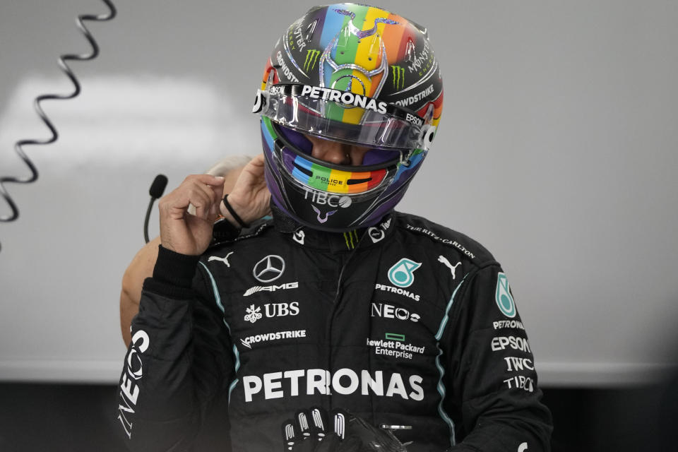 Mercedes driver Lewis Hamilton of Britain adjusts helmet during practice session for the Saudi Arabian Grand Prix in Jiddah, Friday, Dec. 3, 2021. (AP Photo/Hassan Ammar)
