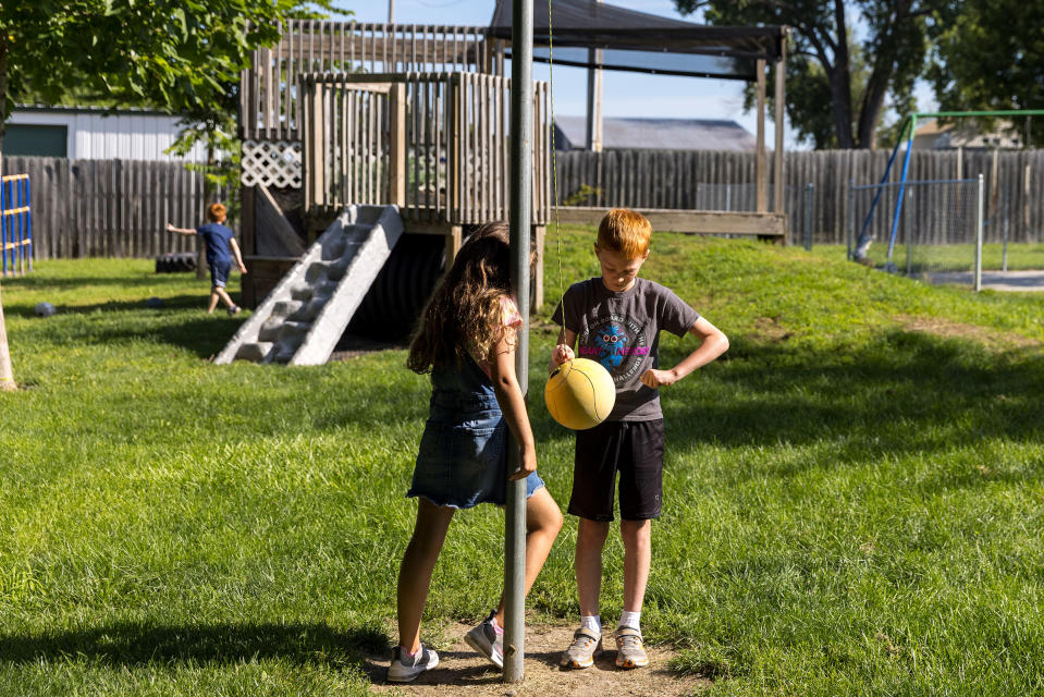 Hunter Rutkowski, age 10, and Alice Nefzger, age 8, play outside. While they will return to school soon, some parents with younger children are still trying to cobble together a new childcare arrangement.<span class="copyright">Kathryn Gamble for TIME</span>