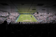 Spectators pack Centre court as Italy's Jannik Sinner and Serbia's Novak Djokovic prepare to start the 5th set in a men's singles quarterfinal match on day nine of the Wimbledon tennis championships in London, Tuesday, July 5, 2022. (AP Photo/Alberto Pezzali)