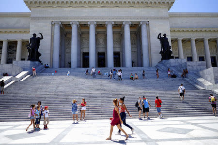 Tourists walk near the main entrance of the Capitol in Havana, Cuba, April 17, 2018. REUTERS/Alexandre Meneghini