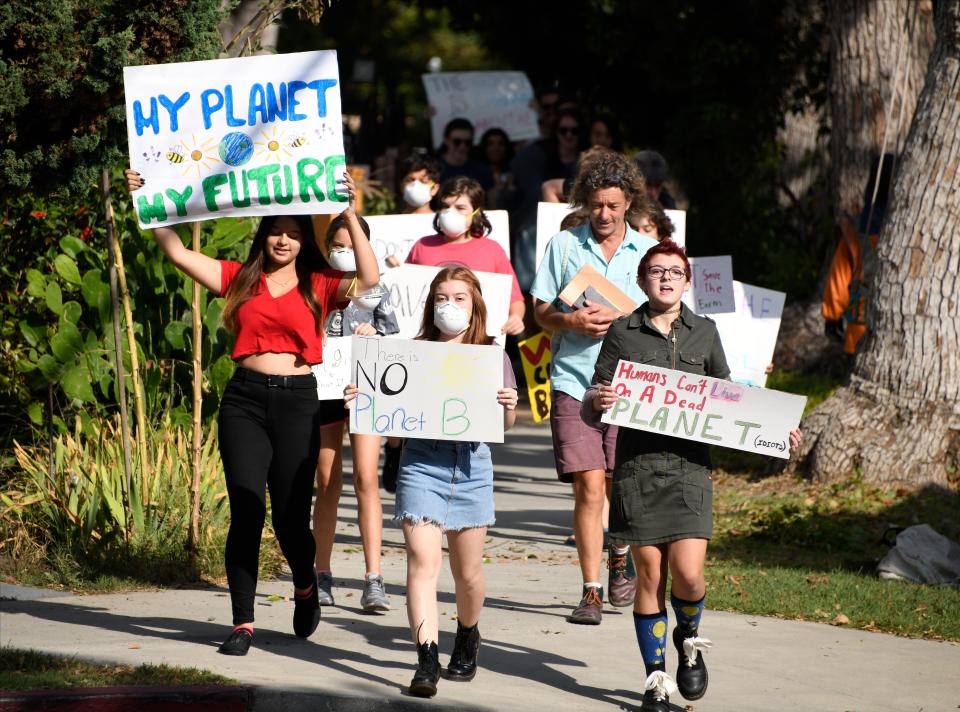 Students from the Urban Homeschoolers in Atwater Village march through the neighborhood chanting and carrying signs on their way to the Los Angeles River and then an overpass on Interstate-5. Photo by Robert Hanashiro, USA TODAY staff