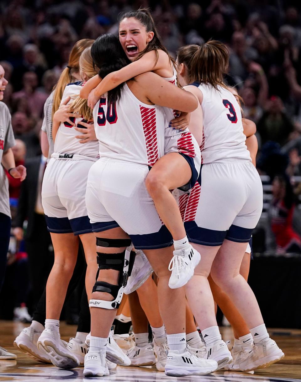 The Bedford North Lawrence Stars celebrate defeating the Fishers Tigers during the IHSAA Class 4A girls basketball state finals championship game Saturday, Feb. 25, 2023 at Gainbridge Fieldhouse in Indianapolis. 