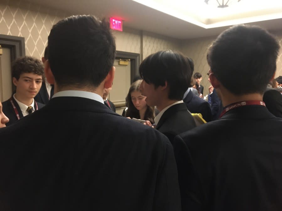 Rileigh Jackson (center) caucusing with other delegates to find common ground on child labor. <br>Photo Credit: Scott Womack