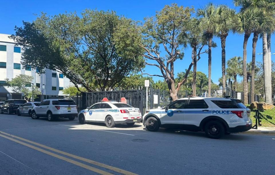 City of Miami police cars parked near the scene where an officer shot a man authorities said was armed with a knife Friday, Feb. 23, 2024.