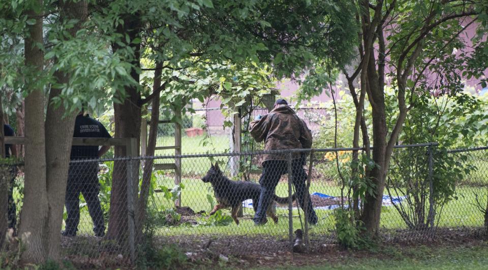 Members of the Michigan State Police and Lansing Police Department's Crime Scene Investigation Unit seen working in the backyard of a home in the 800 block of Loa St. in Lansing, Tuesday, July 2, 2019.