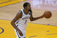 Brooklyn Nets forward Kevin Durant brings the ball up against the Golden State Warriors during the first half of an NBA basketball game in San Francisco, Saturday, Feb. 13, 2021. (AP Photo/Jeff Chiu)