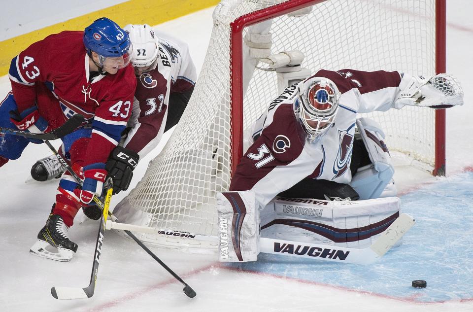 Montreal Canadiens' Daniel Carr (43) moves in on Colorado Avalanche goaltender Calvin Pickard as Avalanche's Francois Beauchemin (32) defends during first period NHL hockey action in Montreal, Saturday, Dec. 10, 2016. (Graham Hughes/The Canadian Press via AP)