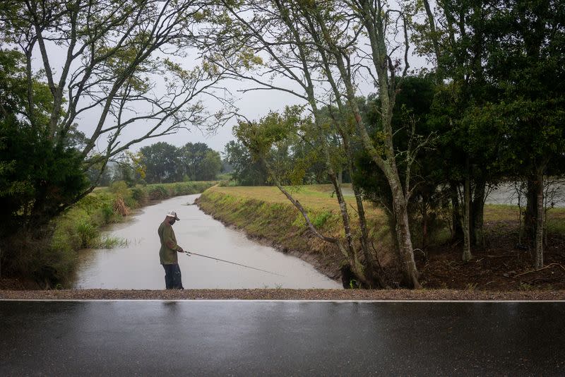 Eric Alexis fishes as Hurricane Delta approaches near Perry