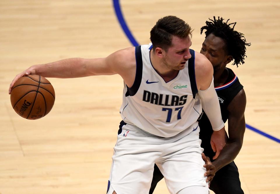 Luka Doncic controls the ball against Patrick Beverley.