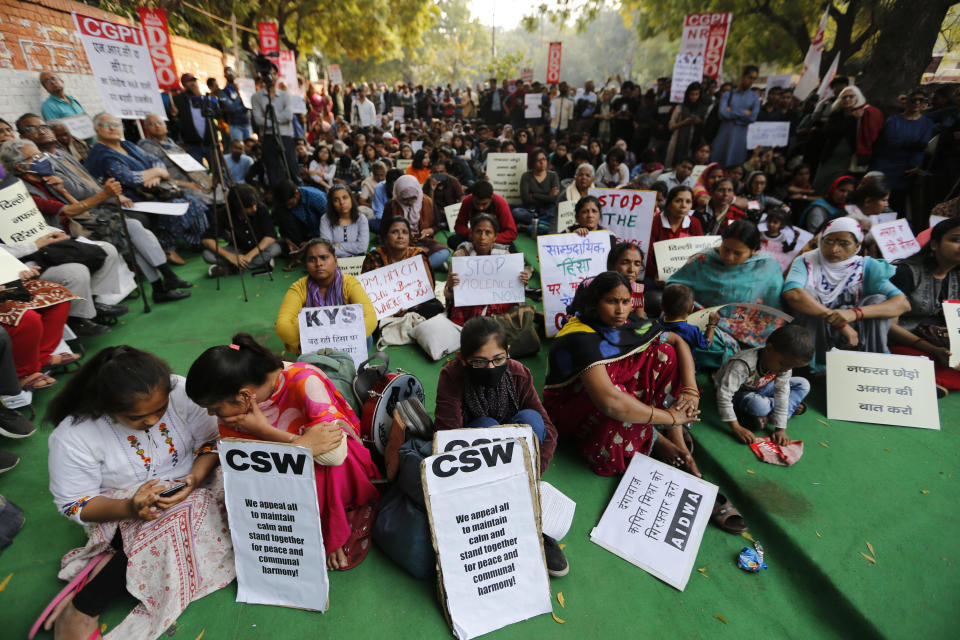 Activists from different organizations hold placards calling for peace and communal harmony following violence in New Delhi, India, Wednesday, Feb. 26, 2020. At least 20 people were killed and 189 injured in three days of clashes in New Delhi that coincided with U.S. President Donald Trump's first state visit to India, with the death toll expected to rise as hospitals continue to take in the wounded, authorities said Wednesday. (AP Photo/Rajesh Kumar Singh)