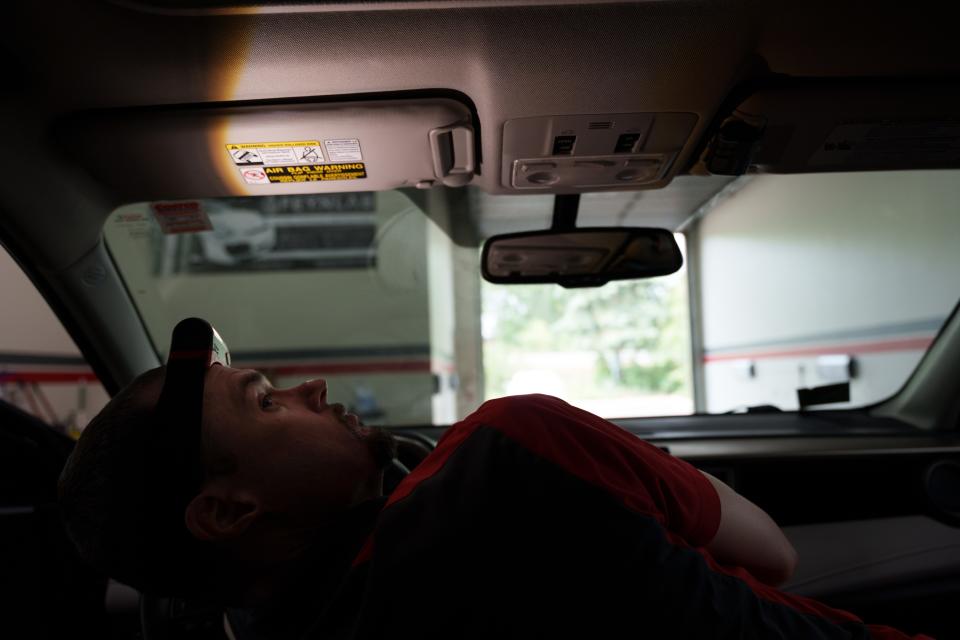 Jay Priebe inspects a customer’s vehicle in his Twin Cities detailing shop.