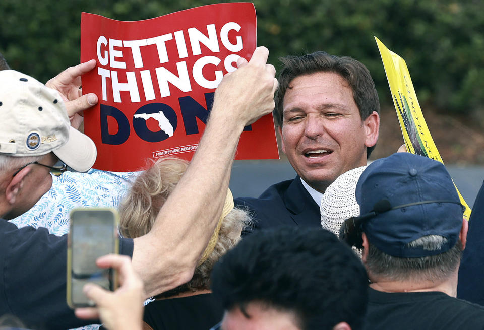 FILE — Florida Governor Ron DeSantis greets supporters during a rally at Freedom Park in the Solivita retirement community in Poinciana, Fla., on Nov. 3, 2022. Both DeSantis a Republican and California Gov. Gavin Newsom, a Democrat said their reelection victories were in part because of their commitment to freedom. But the governors have vastly different definitions of what freedom means. (Stephen M. Dowell/Orlando Sentinel via AP, File)