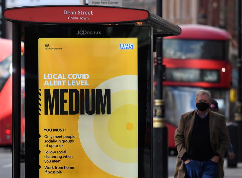 A government local COVID-19 alert level sign is seen at a bus stop in London