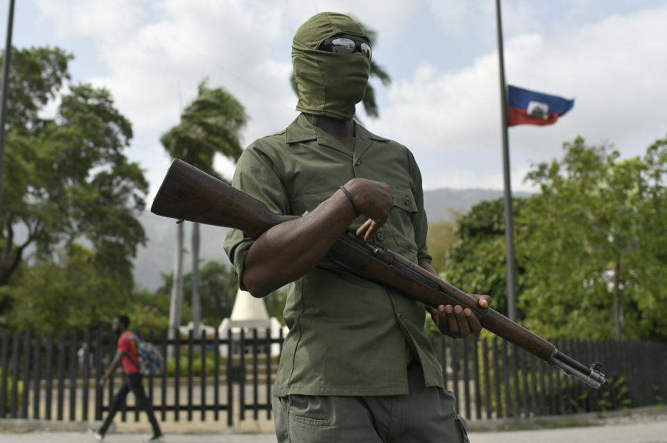 A security guard stands outside the National Pantheon Museum before a ceremony in honor of late Haitian President Jovenel Moise in Port-au-Prince, Haiti, Tuesday, July 20, 2021. Moise was assassinated at home on July 7. (AP Photo/Matias Delacroix)