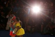 Germany's Angelique Kerber (L) and Serena Williams of the U.S. embrace after Kerber won their final match at the Australian Open tennis tournament at Melbourne Park, Australia, January 30, 2016. REUTERS/Brandon Malone