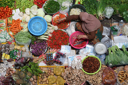 A shopkeeper tends to her stall at Pasar Siti Khadijah at Kota Bharu in Kelantan, Malaysia April 12, 2018. REUTERS/Stringer