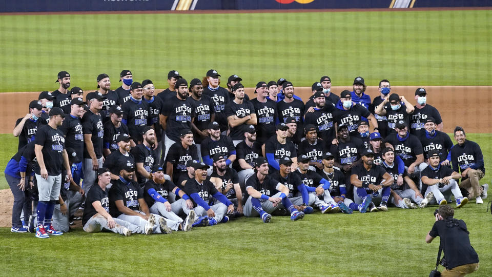 The Los Angeles Dodgers pose for a team picture after defeating the San Diego Padres 12-3 in Game 3 of a baseball National League Division Series early Friday, Oct. 9, 2020, in Arlington, Texas. (AP Photo/Tony Gutierrez)