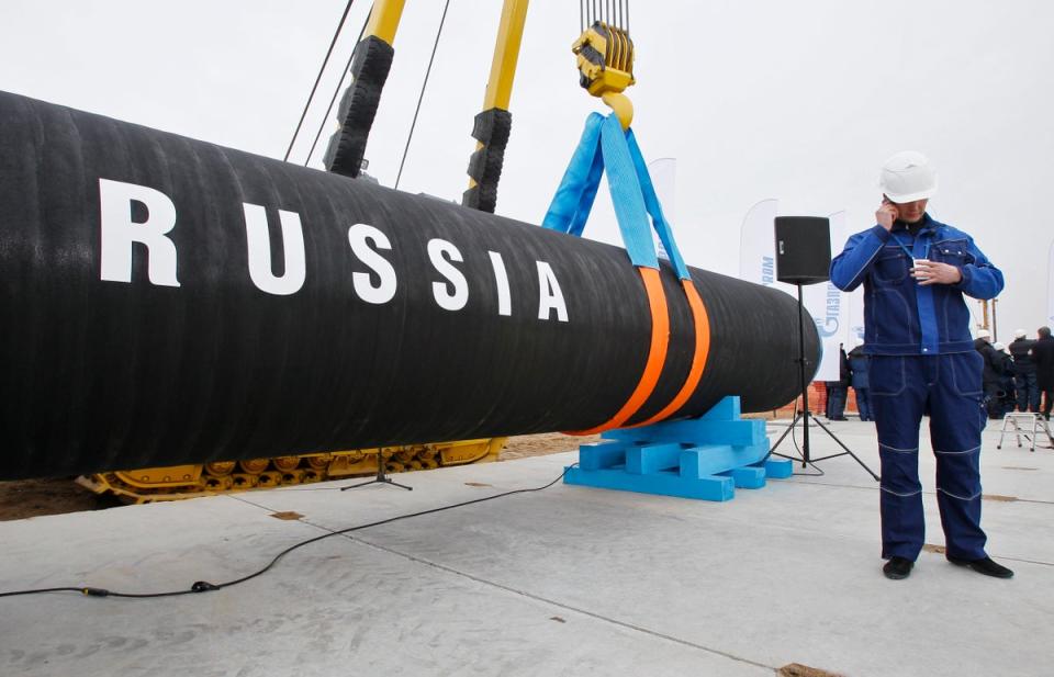 Russian construction worker speaks on a mobile phone during a ceremony marking the start of Nord Stream pipeline in 2010 (AP)