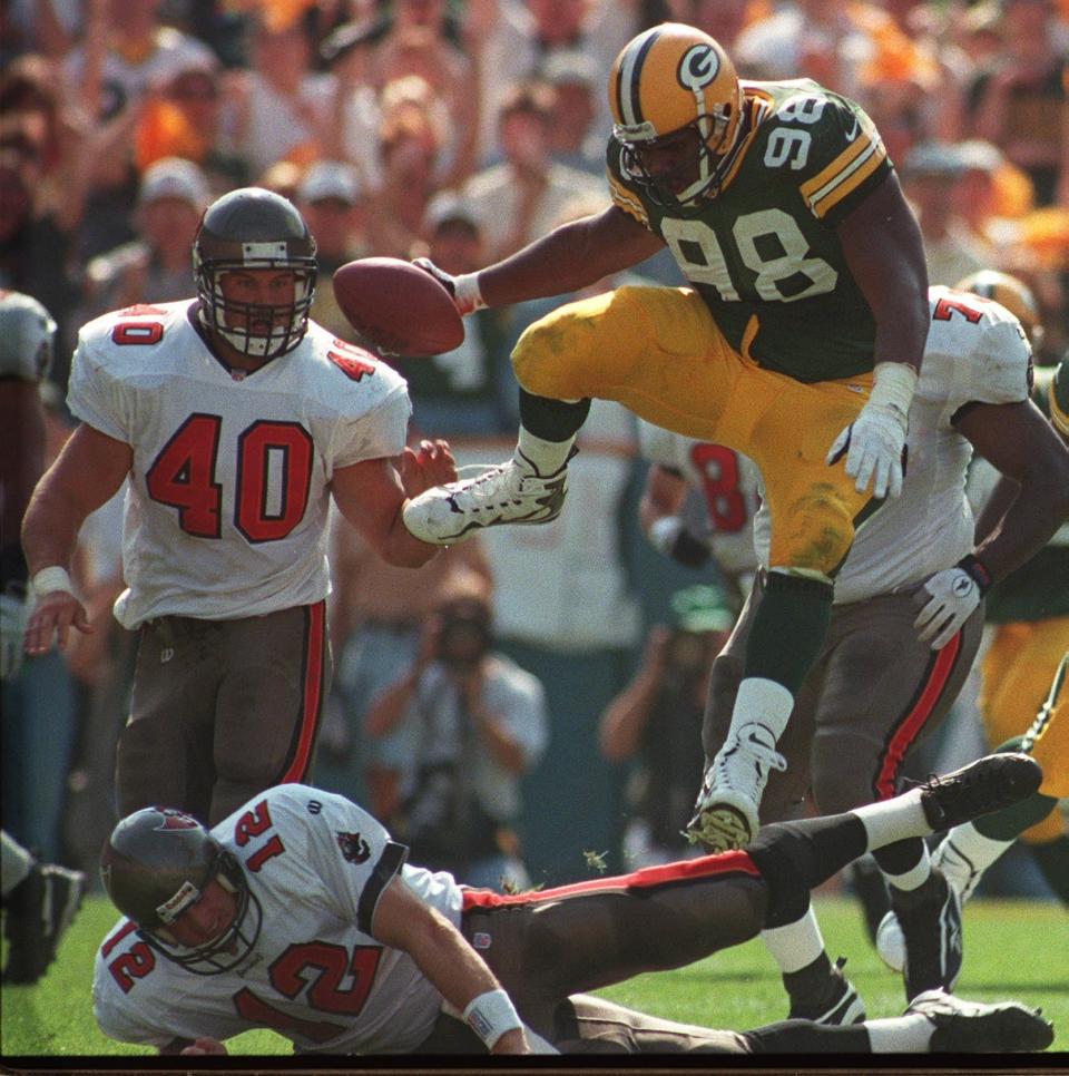 Green Bay Packers defensive tackle Gabe Wilkins hurdles Tampa Bay quarterback Trent Dilfer while returning an interception for a touchdown during the second quarter of their game Sunday, October, 5, 1997 at Lambeau Field in GreenBay, Wis.(Milwaukee Journal Sentinel photo by Jim Gehrz)