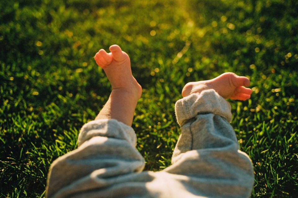 An image of a baby's feet in grass.