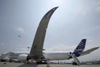 An Airbus A350-900 test plane is seen at Singapore's Changi Airport at a media preview ahead of the upcoming Singapore Air Show on Monday, Feb. 10, 2014. Airbus is showing off its new wide-body A350 at Asia's biggest airshow this week. It's a strong sign the European plane maker is on schedule to start delivering the advanced jet to airline customers in the second half of the year. (AP Photo/Joseph Nair)