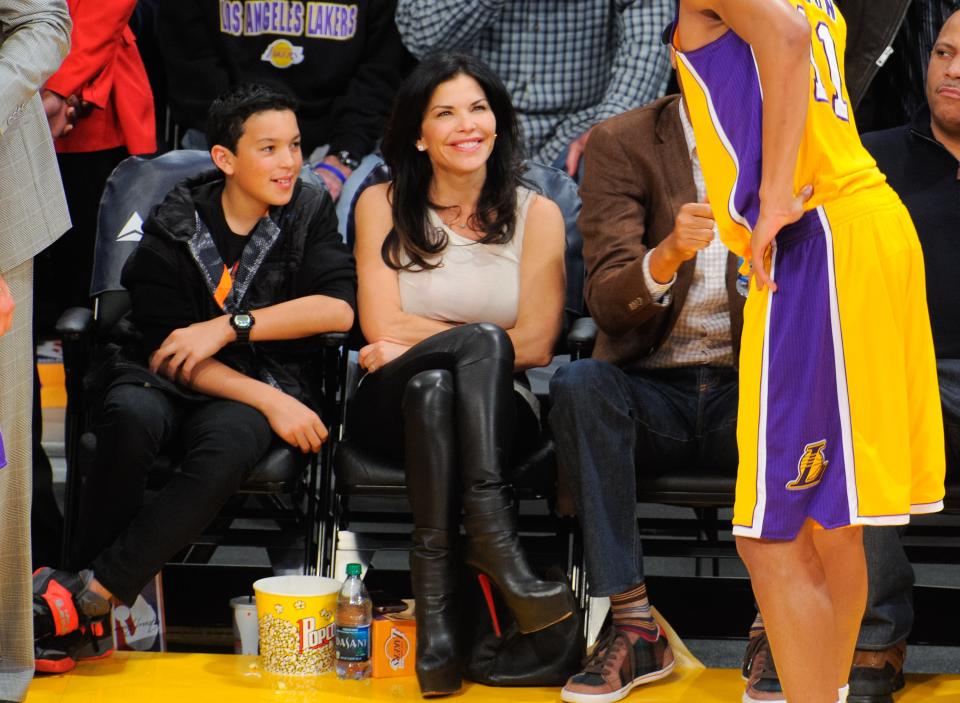 Lauren Sanchez and her son, Nikko Gonzalez, sitting courtside at a Lakers basketball game in 2014.