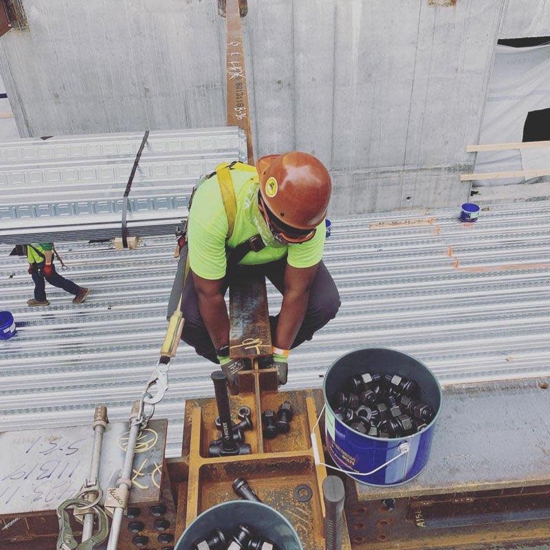 Stoughton ironworker Jessica Devance "stuffing bolts" as she and coworkers build a new school in Chinatown.