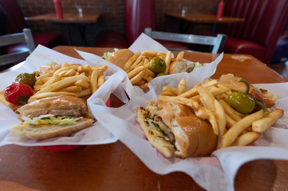 The Super Pass Key Special is an Italian sausage sandwich with American, swiss, and provolone cheese served on a mini-loaf with mustard, lettuce, french fries and mild peppers.