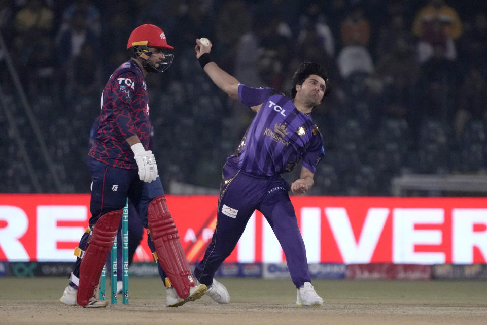 Quetta Gladiators' Mohammad Wasim, right, bowls as Islamabad United Faheem Ashraf watches during the Pakistan Super League T20 cricket match between Islamabad United and Quetta Gladiators, in Lahore, Pakistan Thursday, Feb. 22, 2024. (AP Photo/K.M. Chaudary)