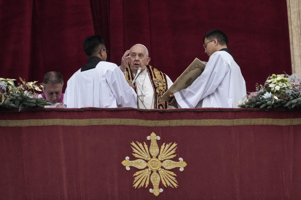Pope Francis delivers the Urbi et Orbi (Latin for 'to the city and to the world' ) Christmas' day blessing from the main balcony of St. Peter's Basilica at the Vatican, Monday Dec. 25, 2023. (AP Photo/Gregorio Borgia)