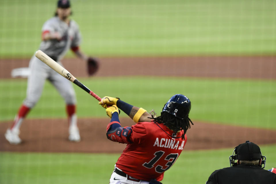 Atlanta Braves' Ronald Acuna Jr. (13) follows through on a home run to left field on a pitch by Boston Red Sox' Chris Mazza, top, during the first inning of a baseball game Friday, Sept. 25, 2020, in Atlanta. (AP Photo/John Amis)