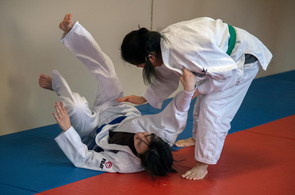 Hiromi Hernandez, right, flips Kimberly Misenhimer during a practice of the Stockton Judo Club at the McKinley Park Community Center in south Stockton.