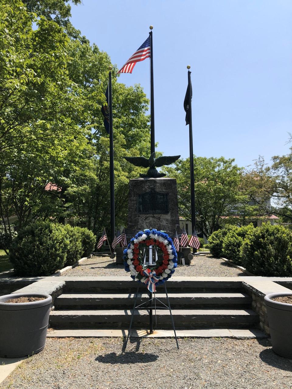 A wreath is seen at the veterans memorial on Broad Street in Milford on May 18, 2023.