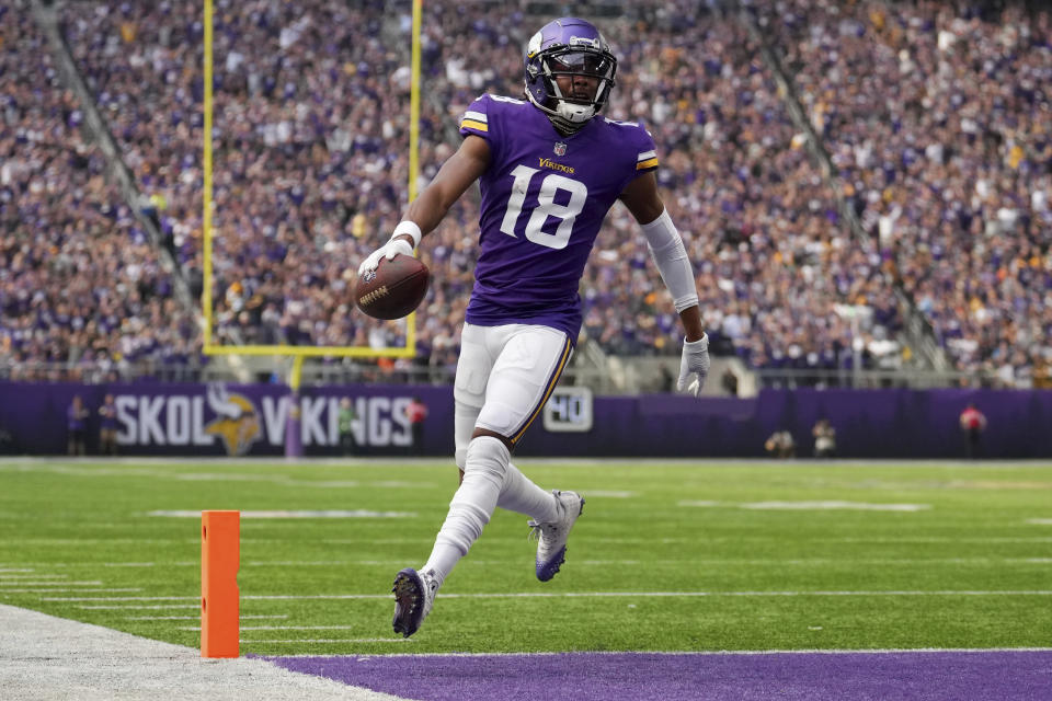 Minnesota Vikings wide receiver Justin Jefferson runs the ball in for a touchdown off a pass from quarterback Kirk Cousins in the first quarter of an NFL season opener game against the Green Bay Packers, Sunday, Sept. 11, 2022, in Minneapolis. (Anthony Souffle/Star Tribune via AP)