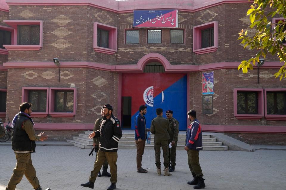 File. Police officers gather outside a police station, in Warburton, an area of district Nankana, Pakistan, Sunday, 12 February 2023. Hundreds of Muslims descended on a police station in Pakistan's eastern Punjab province, snatched Waris, a blasphemy suspect from his cell and took him outside and lynched him, police said (Associated Press)