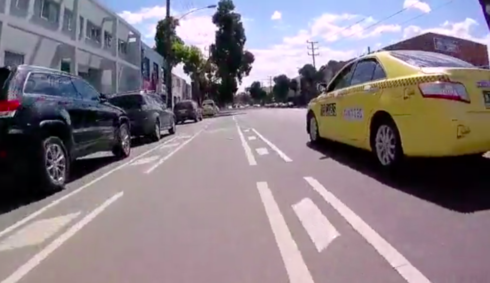 The cyclist approaches on the left as the taxi begins to slow. Source: Facebook/ Cycliq