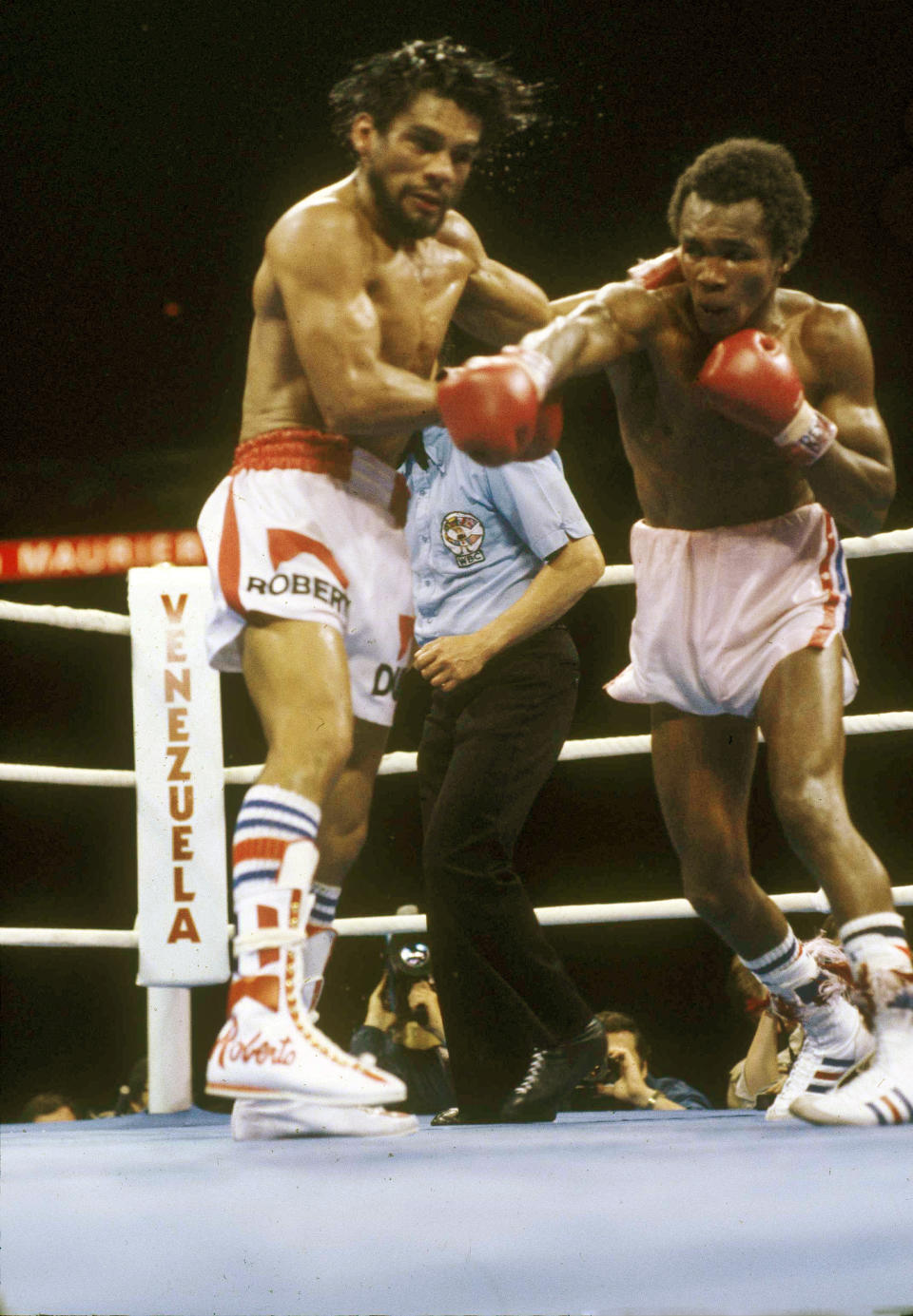 FILE - This June 20, 1980 file photo shows Roberto Duran, left, taking a punch from Sugar Ray Leonard during their title fight in Montreal, Quebec, Canada. The documentary, "I am Duran," about Panamanian boxing legend Roberto Duran, will be available for digital download on multiple platforms June 4. (AP Photo, File)