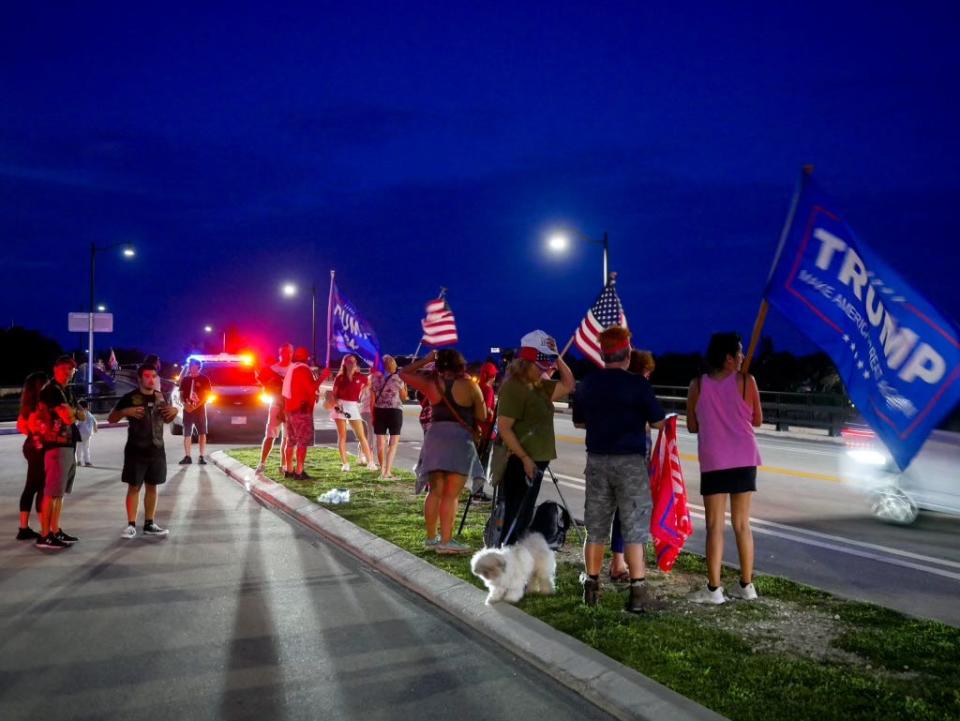 Supporters of former President Donald Trump line Southern Boulevard near his Mar-a-Lago Club in Palm Beach on Saturday, July 13, following a shooting in which Trump was injured at his rally in Pennsylvania earlier in the day.