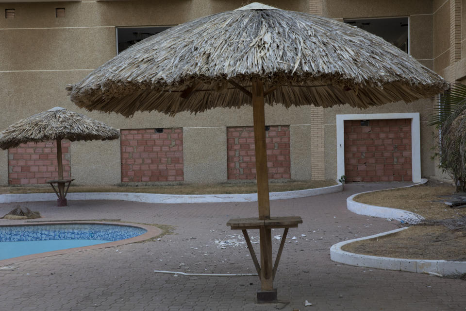 Entryways into the Brisas del Norte hotel are bricked up to keep people from squatting on the property, after it was looted two months prior in Maracaibo, Venezuela, May 15, 2019. Residents, seemingly driven to desperation by nationwide power blackouts, looted and destroyed hundreds of buildings and businesses in March. (AP Photo/Rodrigo Abd)